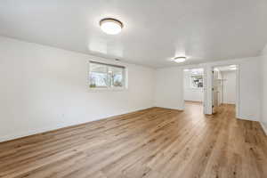 Basement with light wood-type flooring