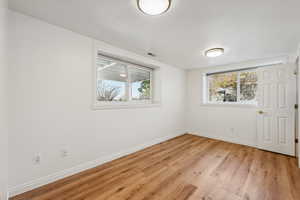 Unfurnished room with light hardwood / wood-style flooring