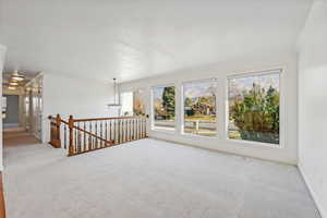 Spare room with crown molding and light colored carpet