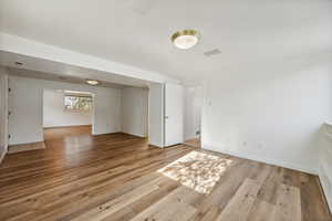 Empty room with light hardwood / wood-style floors