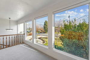 Unfurnished sunroom with a mountain view