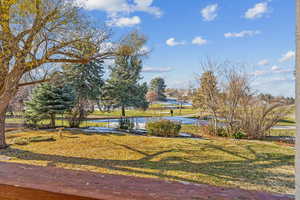 View of community featuring a water view and a yard