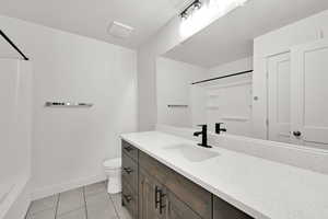 Bathroom featuring tile patterned flooring, vanity, and toilet