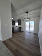 Unfurnished living room with sink and dark hardwood / wood-style floors