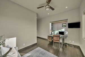 Office with ceiling fan and dark wood-type flooring