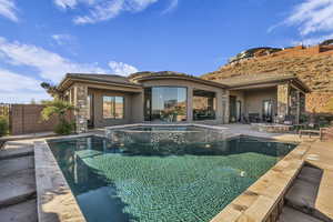 View of pool featuring a patio area and an in ground hot tub