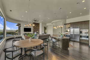 Dining room featuring dark hardwood / wood-style floors and ceiling fan with notable chandelier