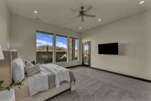 Bedroom with ceiling fan, light carpet, and access to outside