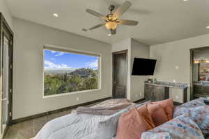 Bedroom with ceiling fan and connected bathroom