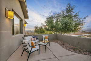 Patio terrace at dusk featuring an outdoor living space