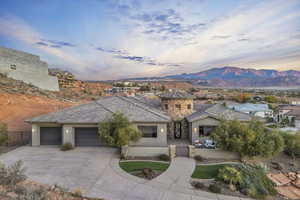 View of front of house with a mountain view and a garage