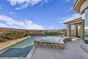 View of swimming pool featuring an in ground hot tub