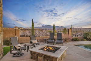 View of patio with a mountain view and a fire pit