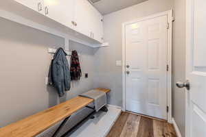 Mudroom featuring a textured ceiling and hardwood / wood-style flooring