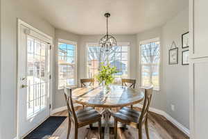 Dining space with plenty of natural light and wood-type flooring