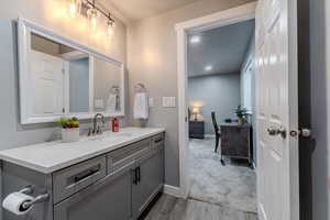 Bathroom with vanity and wood-type flooring