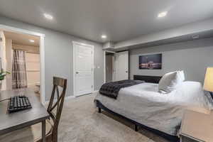 Bedroom with carpet floors and ensuite bathroom