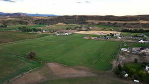 Aerial view at dusk featuring a mountain view and a rural view