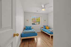 Bedroom featuring ceiling fan and light hardwood / wood-style flooring