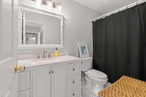 Bathroom with tile patterned floors, vanity, and toilet