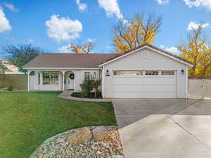 Ranch-style house featuring a front lawn and a garage