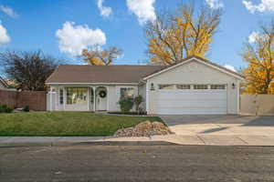 Ranch-style home with a front yard and a garage