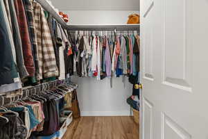 Spacious closet featuring hardwood / wood-style floors