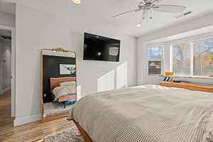 Bedroom featuring ceiling fan and light wood-type flooring