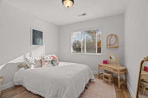 Bedroom with hardwood / wood-style floors