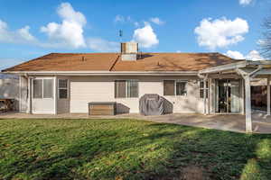 Back of house with a lawn, a patio area, and cooling unit