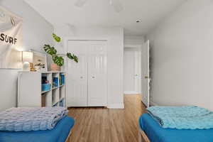 Bedroom featuring hardwood / wood-style flooring, ceiling fan, and a closet