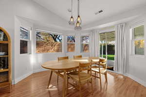 Dining room featuring light hardwood / wood-style floors and vaulted ceiling