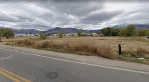 Property view of mountains with a rural view