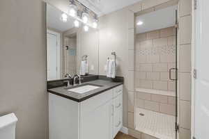 Bathroom featuring vanity and an enclosed shower