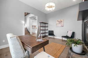 Office featuring a notable chandelier and hardwood / wood-style flooring