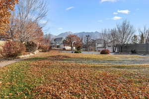 View of yard with a mountain view and basketball hoop