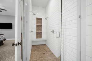 Bathroom with tile patterned flooring, an enclosed shower, and ceiling fan