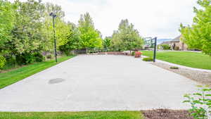 Exterior space featuring a yard and basketball court