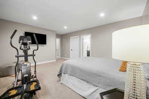 Carpeted bedroom with ensuite bathroom