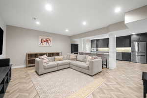 Living room featuring light parquet flooring