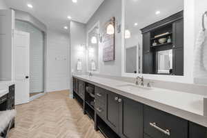 Bathroom with vanity, parquet floors, walk in shower, and wooden walls