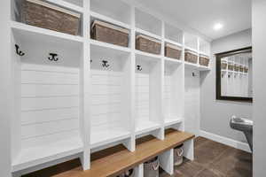 Mudroom featuring dark tile patterned flooring