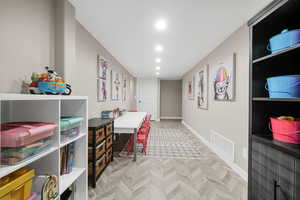 Recreation room with light parquet flooring