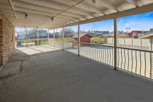 Huge covered patio off of the main level with steps to the lower level and yard.