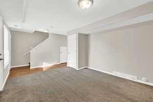 Unfurnished living room with dark wood-type flooring