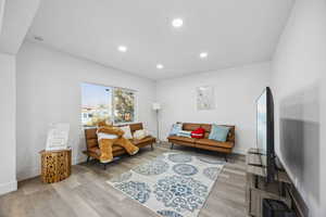 Living room with light hardwood / wood-style flooring