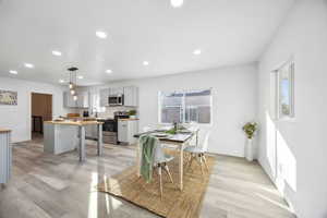 Dining room with sink and light hardwood / wood-style floors