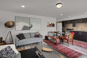 Living room with sink and light wood-type flooring