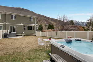 View of yard with a mountain view and a hot tub