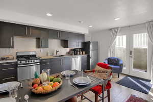 Kitchen featuring light wood-type flooring, sink, appliances with stainless steel finishes, and french doors